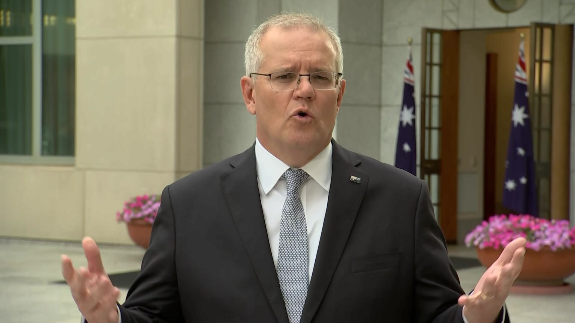 The Prime Minister Scott Morrison waves his arms during an interview