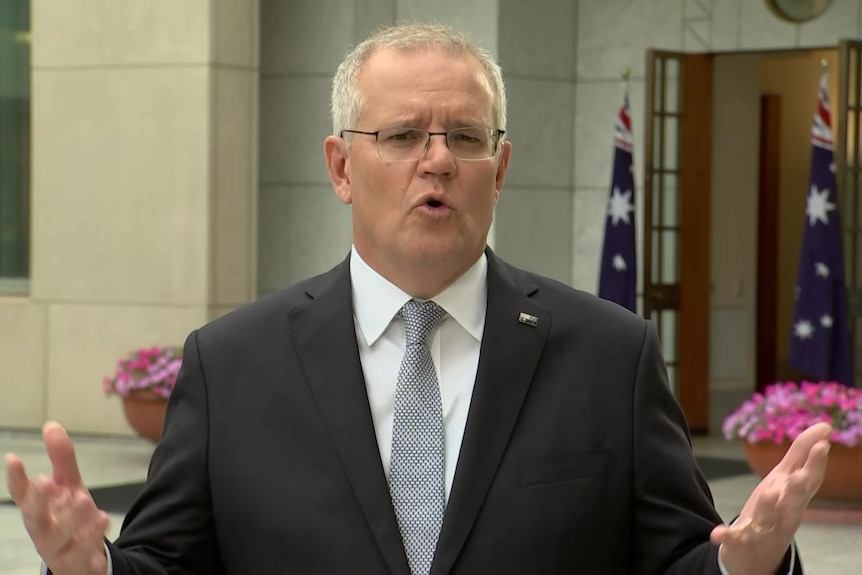 The Prime Minister Scott Morrison waves his arms during an interview