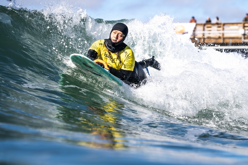 Para surfer Jocelyn Neumueller catches a wave