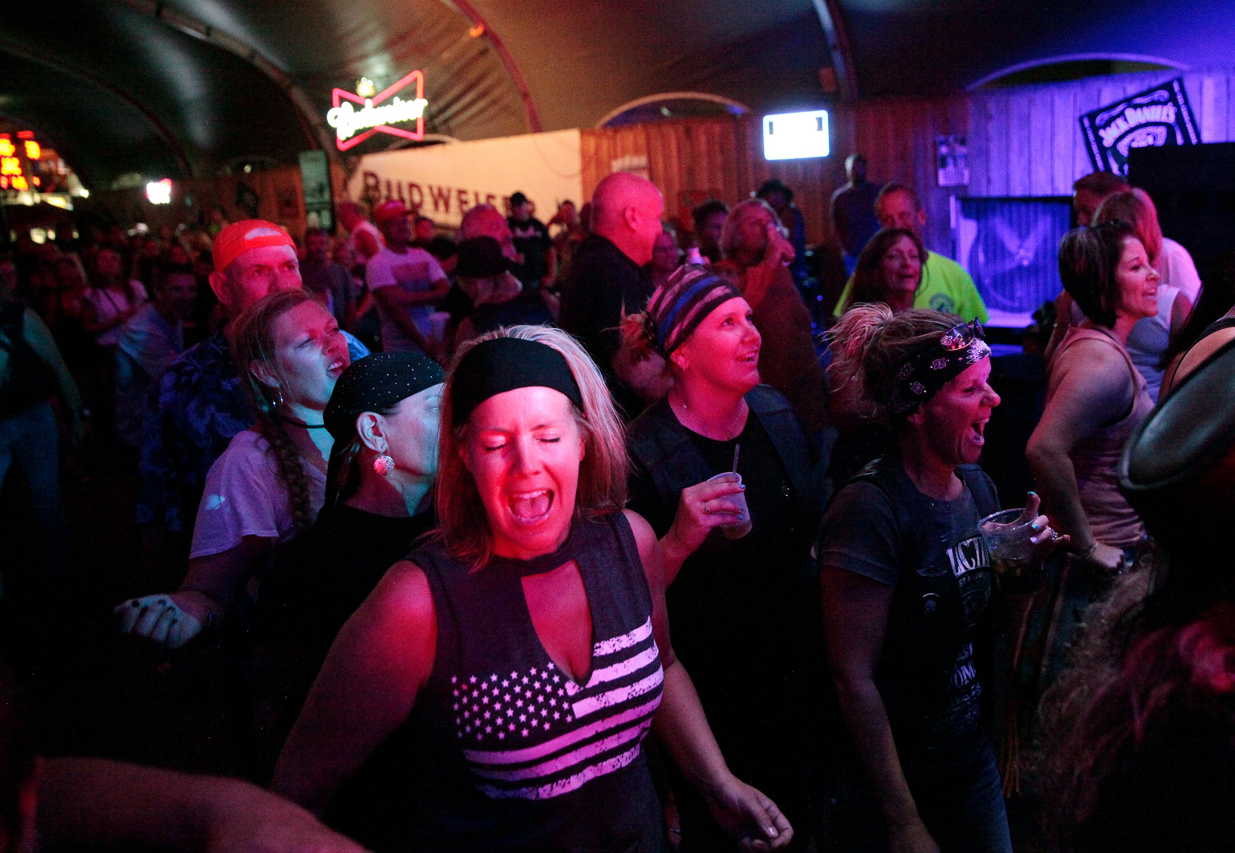 People dance in a crowded bar.