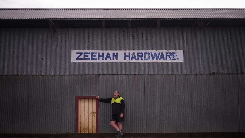 Zeehan hardware store owner, Don Edmonston, stands outside his business.