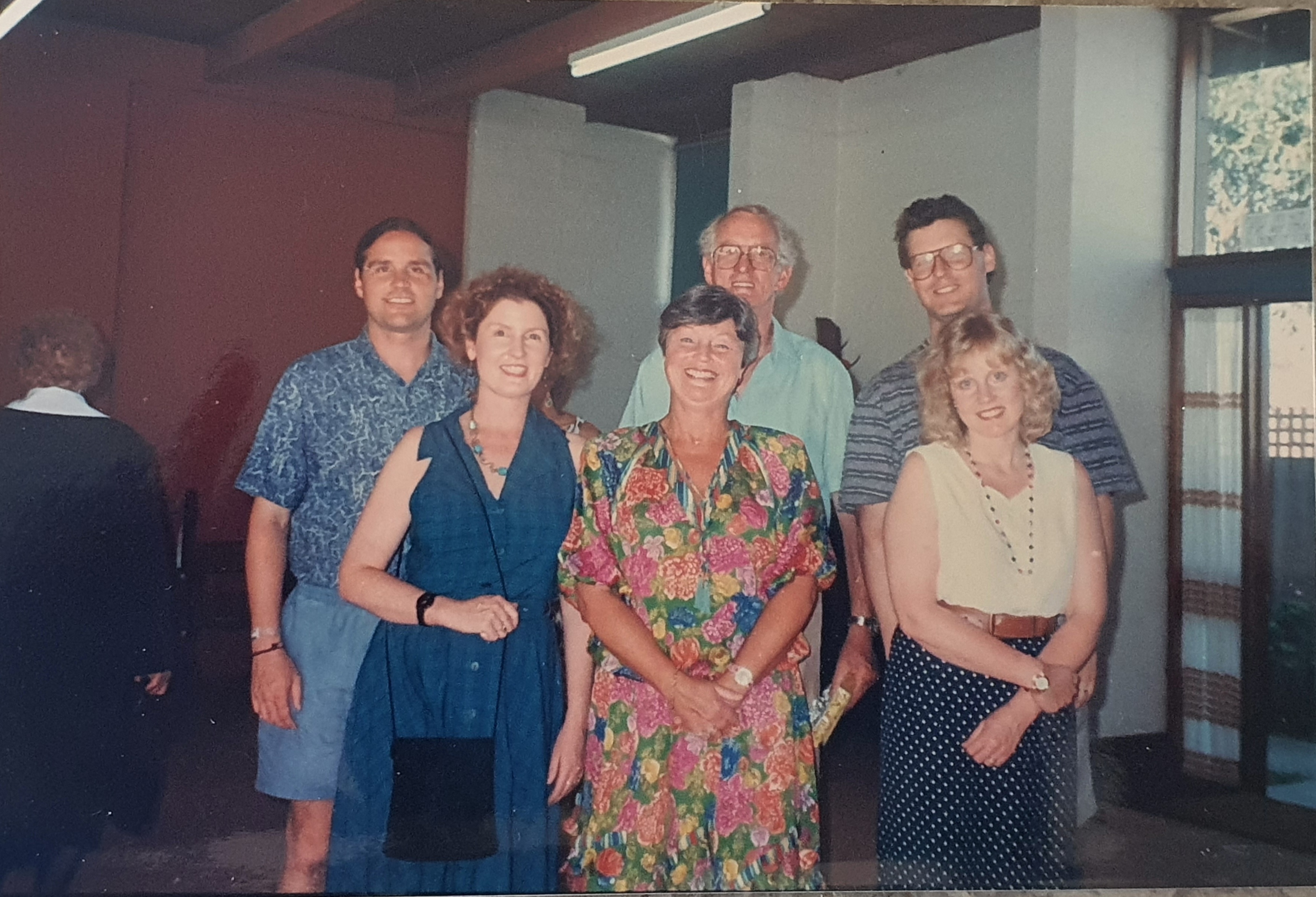 A family photo of three women and three men standing together.