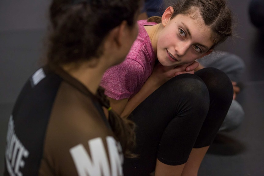 Cassia looks up at Shantelle Thompson, as she speaks to her about discipline.