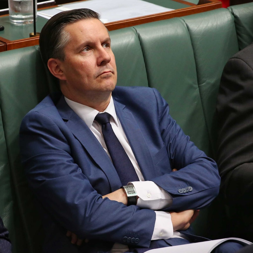 Mark Butler sits with his arms crossed looking to the sky in the House of Representatives