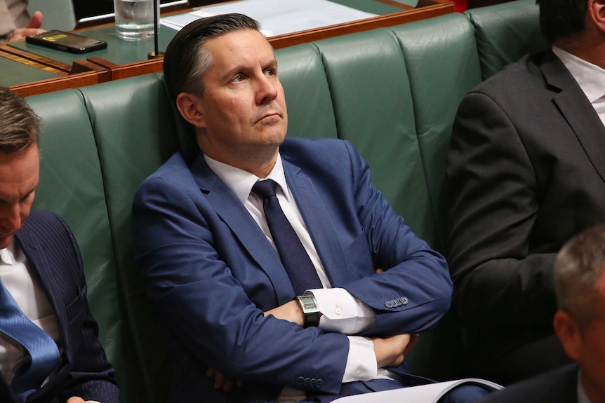 Mark Butler sits with his arms crossed looking to the sky in the House of Representatives