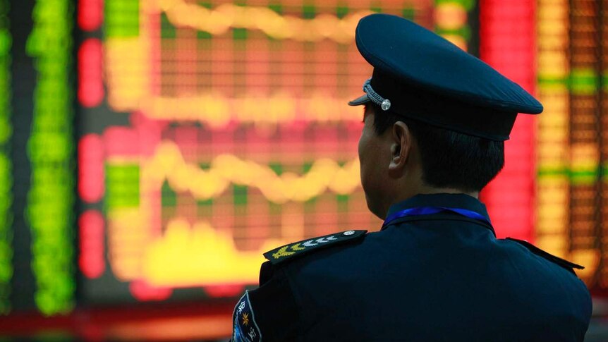 A guard in front of the securities exchange screen in Huaibei.