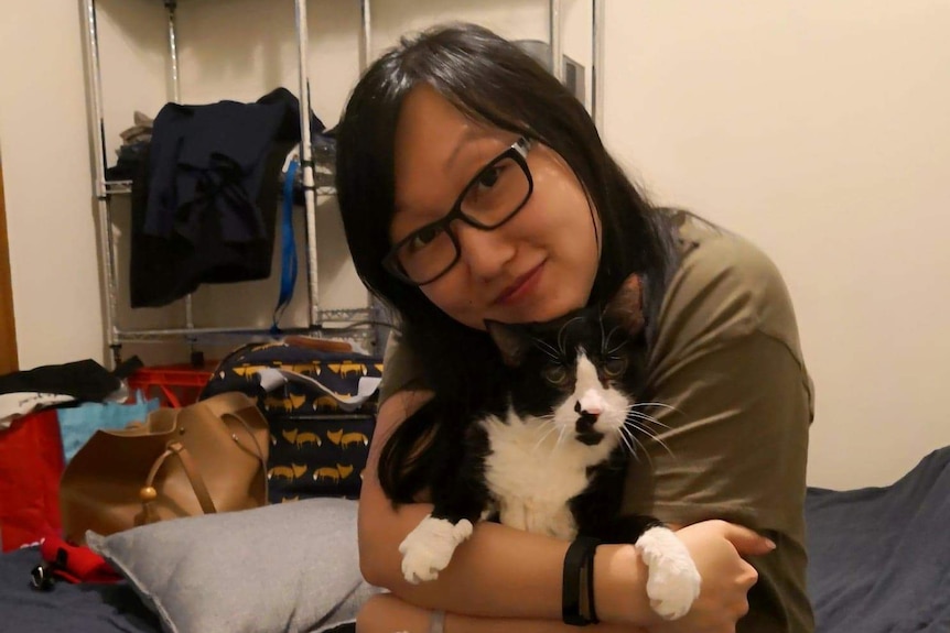 Jenny Zhang with one of the cats she left behind in her apartment.