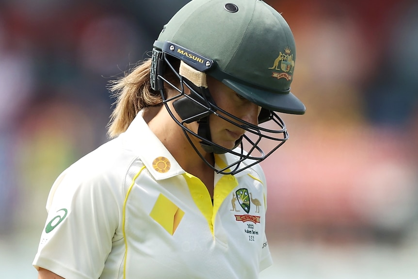 Ellyse Perry leaves the field with her head down