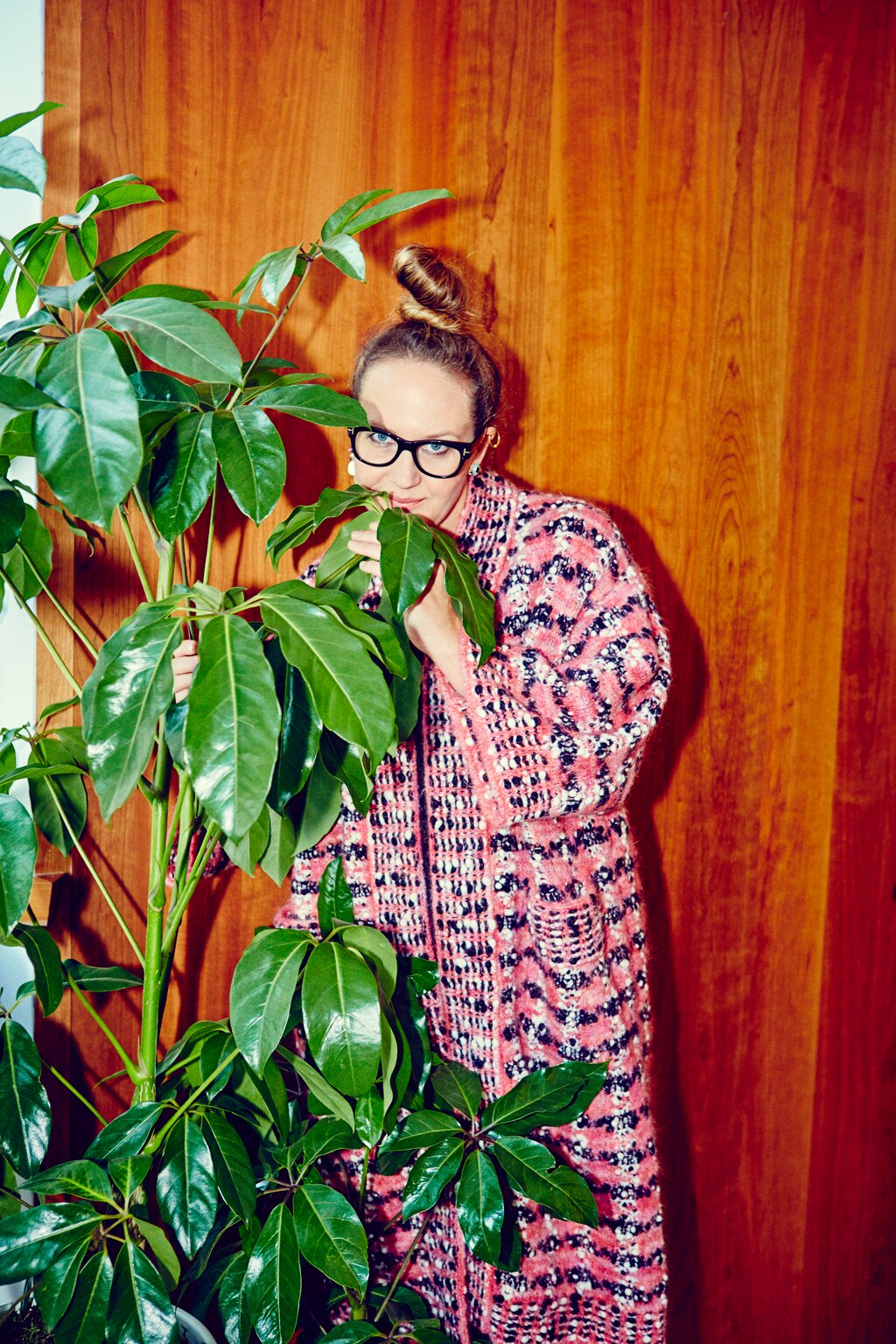 Del Kathryn Barton hiding behind a large indoor plant