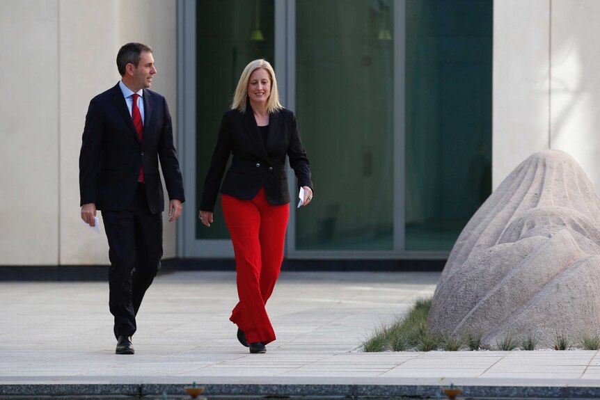 Jim Chalmers and Katy Gallagher walk through a courtyard at Parliament House