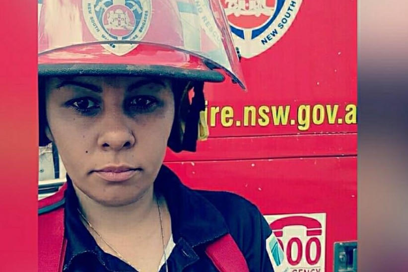 Close-up of woman in firefighter's helmet.
