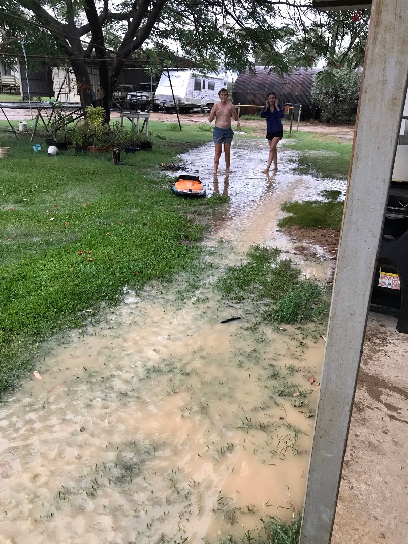 kids play in flooded backyard