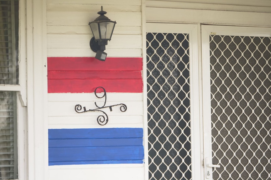 A close up of the red, white and blue stripes painted on Shannon Yates' house