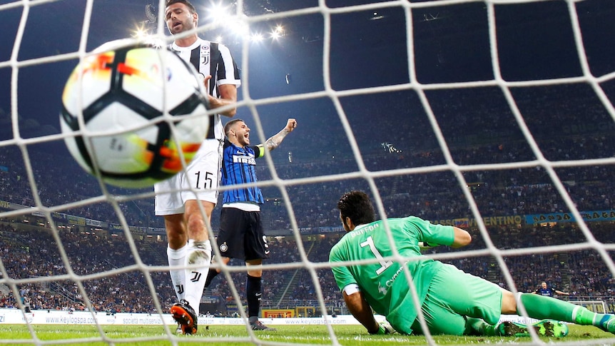 Juventus' Andrea Barzagli looks dejected after scoring an own goal as Inter Milan's Mauro Icardi celebrates
