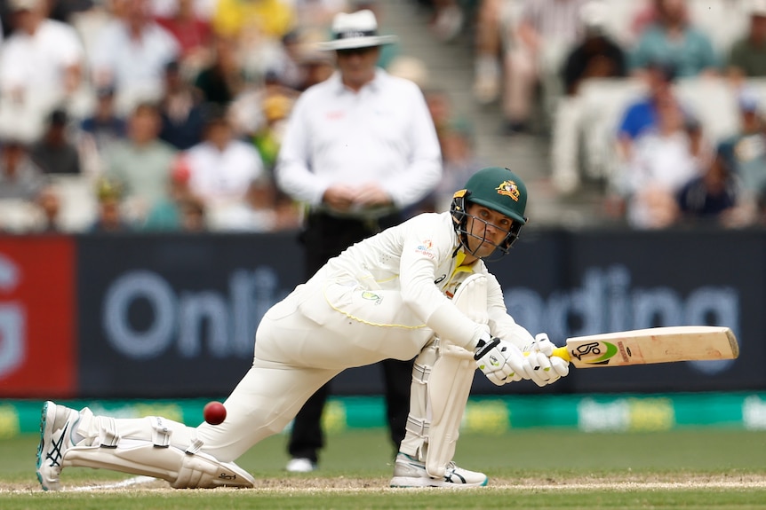 Australia batter Alex Carey plays a sweep shot in a Test against South Africa at the MCG.