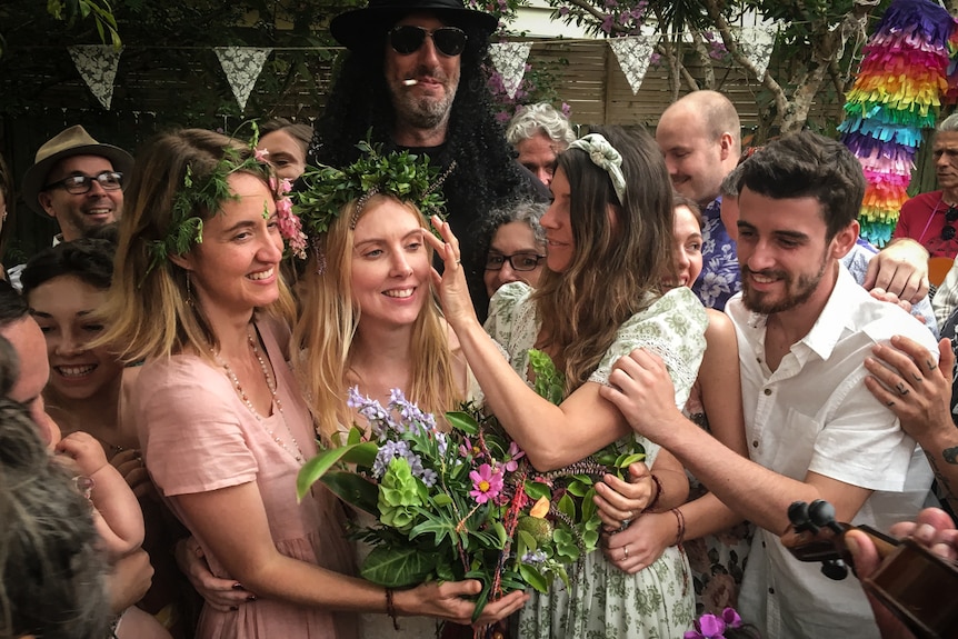 Bride surrounded by friends at wedding in a story about women marrying without partners.