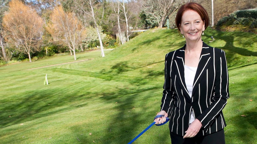 Former Australian prime minister Julia Gillard walks her Cavoodle, Reuben.