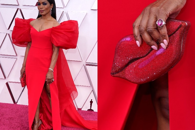 Angela Bassett in red gown with lips clutch bag