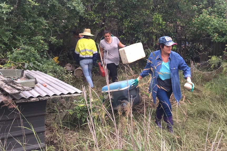 Volunteers part of the "Mud Army" at a Logan property helping to clean up