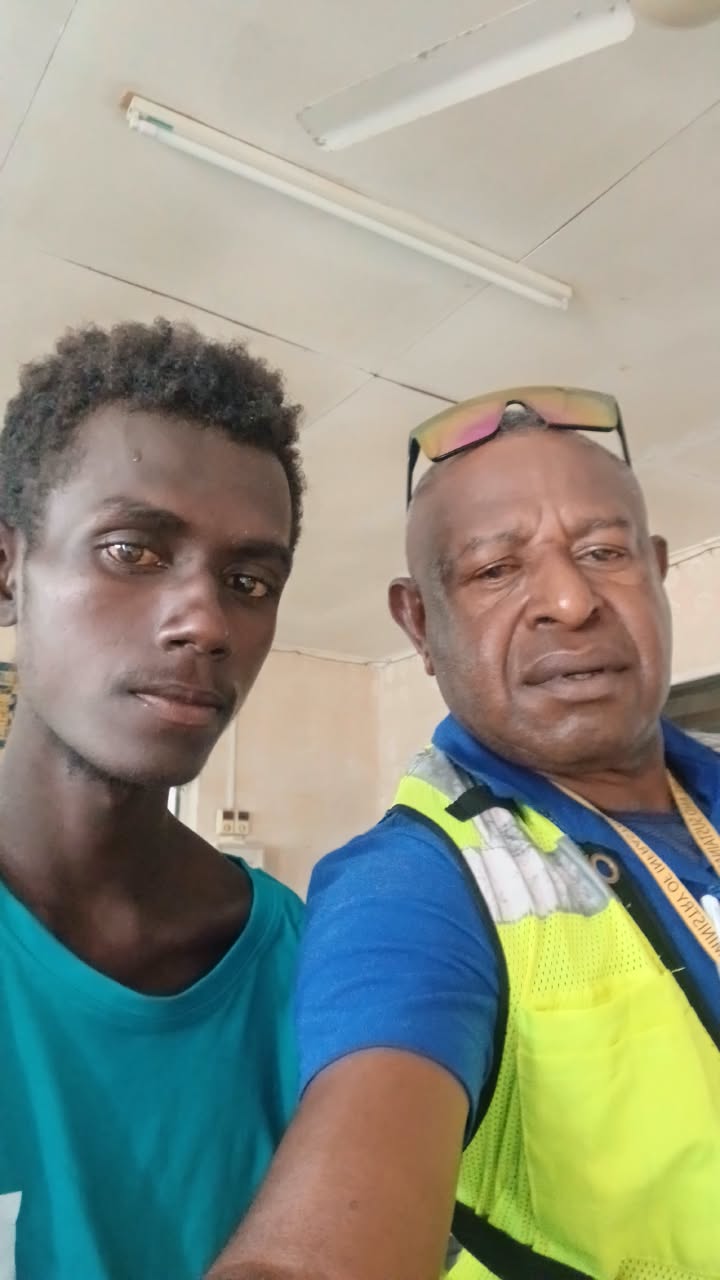 Two men take a selfie together.