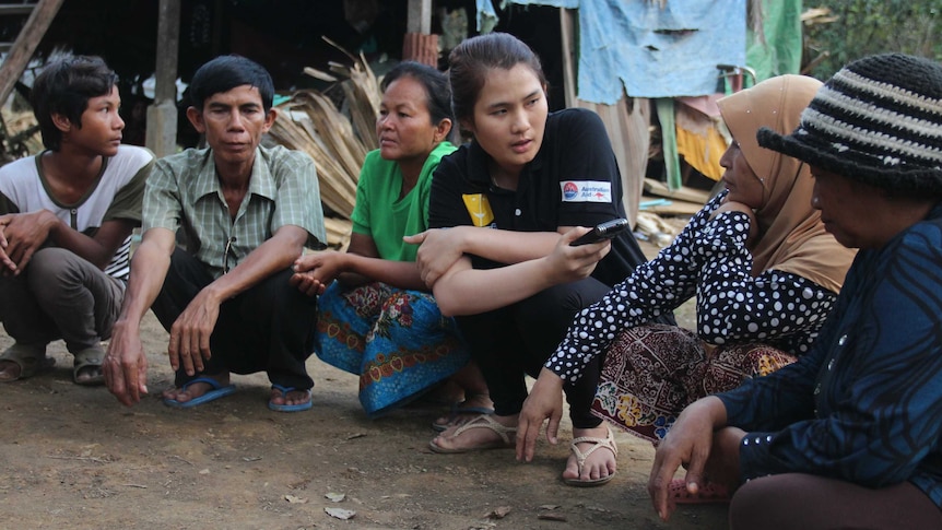 Group of Cambodian citizens being interviewed by a female journalist