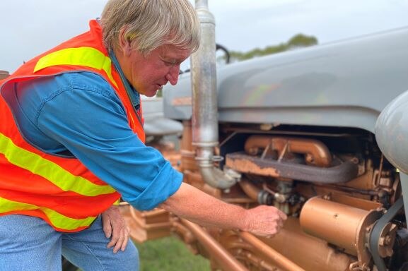 Tractor enthusiast Bob Hughes takes a look under the hood of the Ferguson.