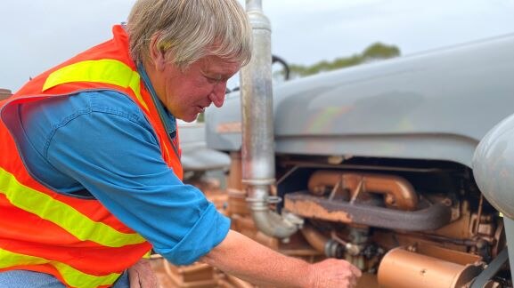 Tractor enthusiast Bob Hughes takes a look under the hood of the Ferguson.