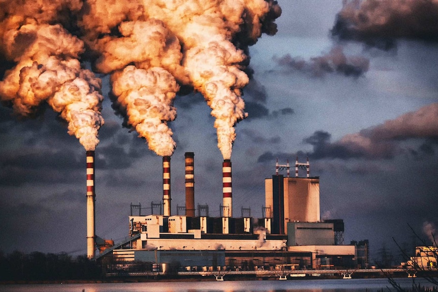 A power plant emits steam from cooling towers.