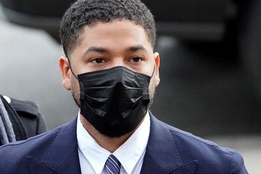 Jussie Smollet, a Black man wearing a mask