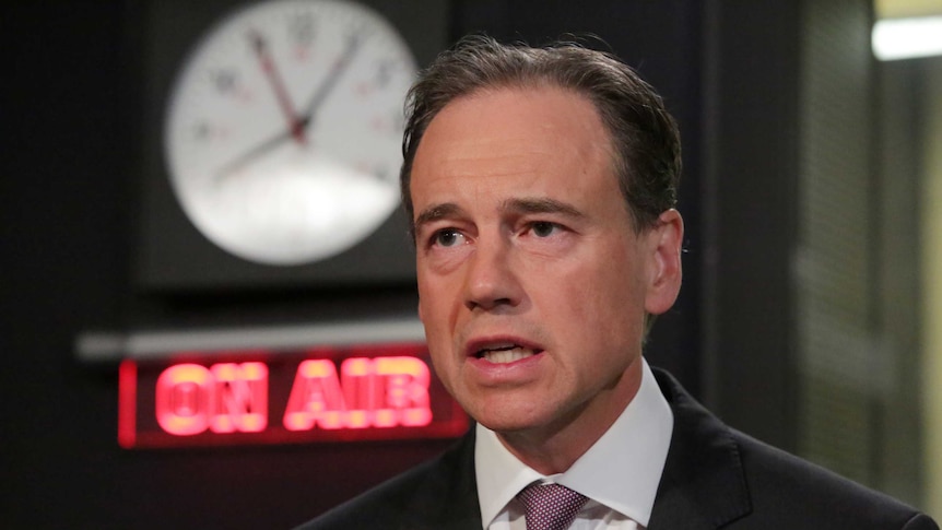 Health Minister Greg Hunt being interviewed in an ABC Radio studio.
