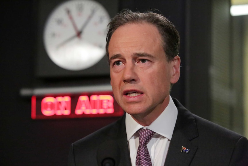 Health Minister Greg Hunt being interviewed in an ABC Radio studio.