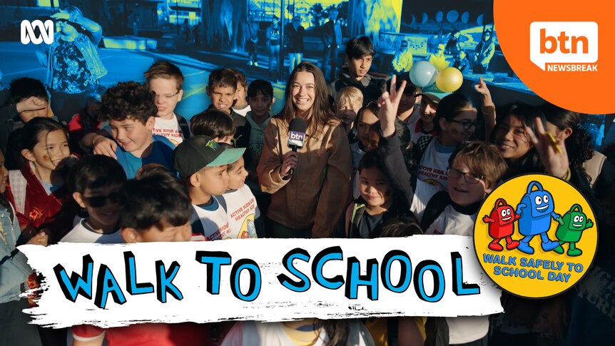 Newsbreak presenter Wren surrounded by students as part of Walk to School Day. 