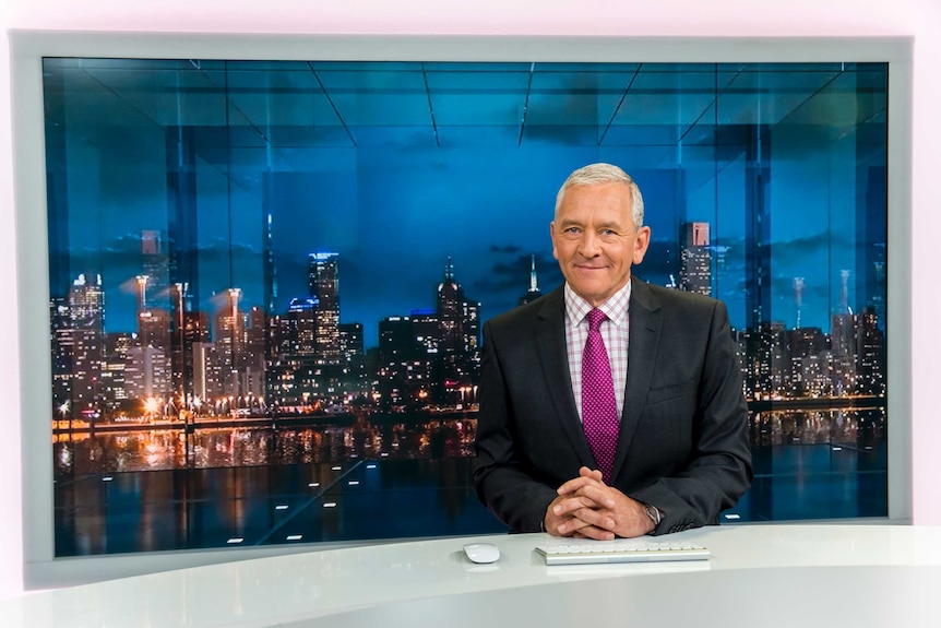 Ian Henderson sits at the ABC News desk.