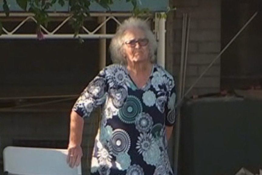 Adrienne Krist stands outside her home where she is self isolating