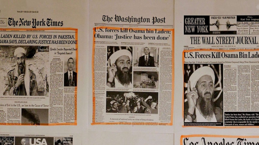 Newspapers bearing headlines of Osama Bin Ladens death are spread out.