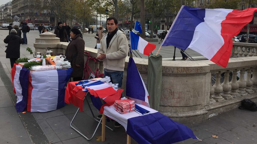 Budding entrepreneurs selling the French flag near the Place de la Republique