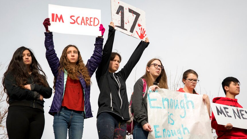 Students recognise the 17 victims, holding the number 17 and posters reading "i'm scared" and "enough is enough"
