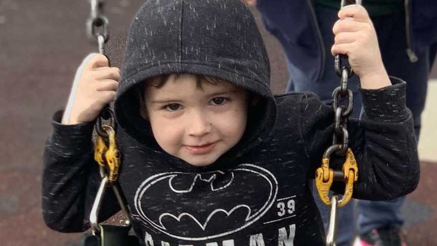 Debbie pushes her grandson on the swings.