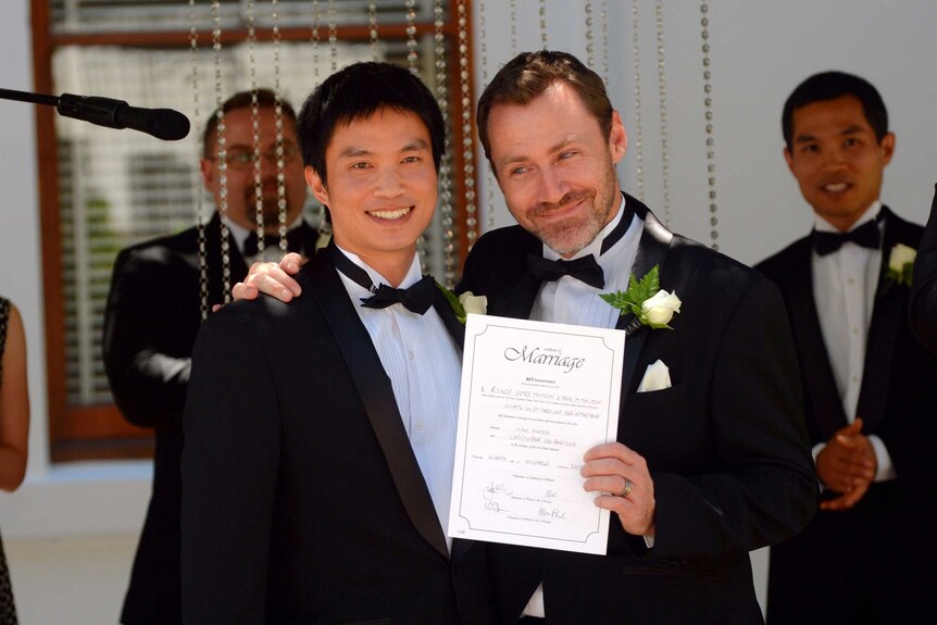 Ivan Hinton and his partner display their marriage certificate.