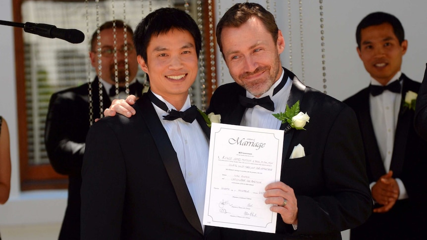Ivan Hinton and his partner display their marriage certificate