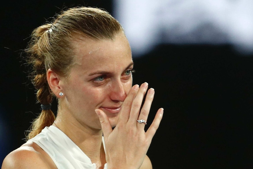 Petra Kvitova wipes her face as she cries during a post-match interview at Australian Open.