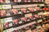 a supermarket fridge section full of steak