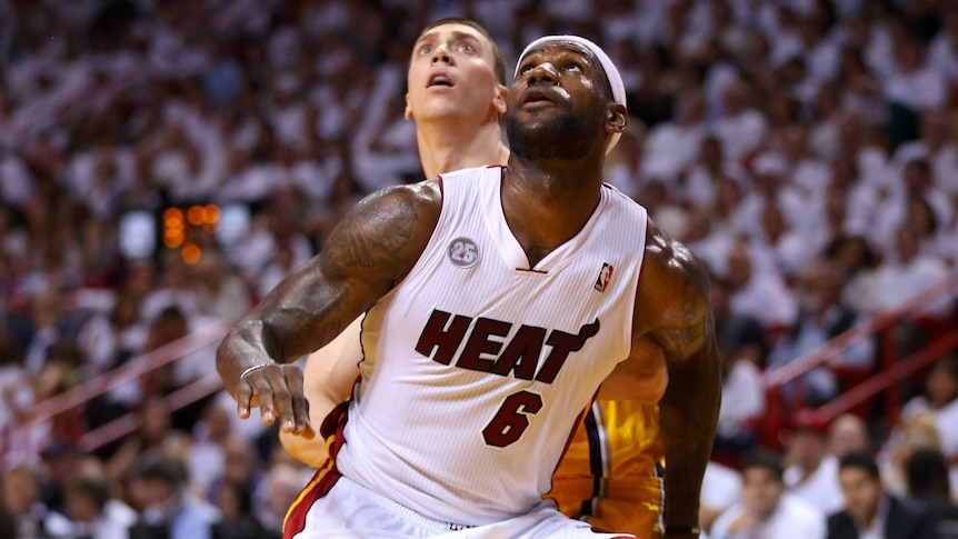 Eyes on the prize ... LeBron James fights for position with Tyler Hansbrough