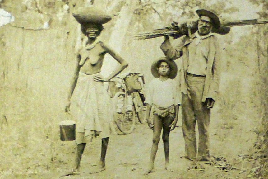Aboriginal family, semi-naked woman partically dressed in European clothes.