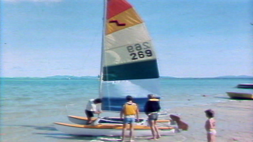 A catamaran on a beach at South Molle Island in a TV still from 1986.