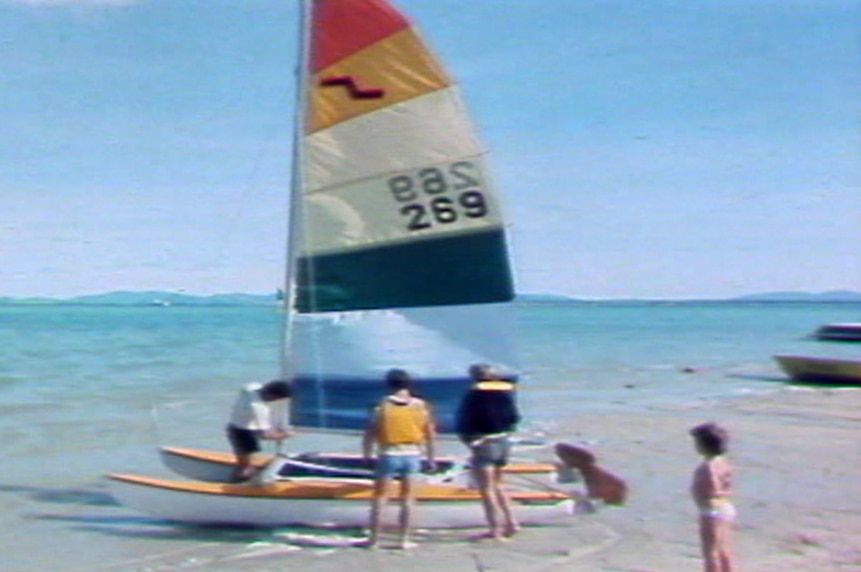 A catamaran on a beach at South Molle Island in a TV still from 1986.