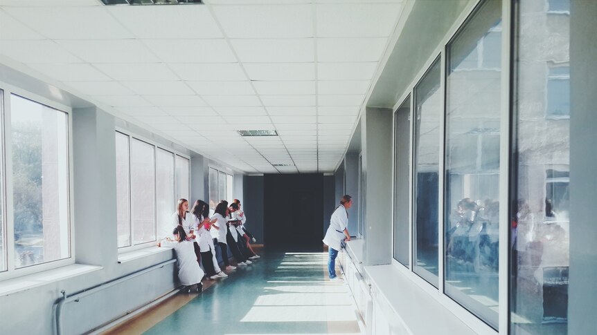 People waiting in a hospital corridor.