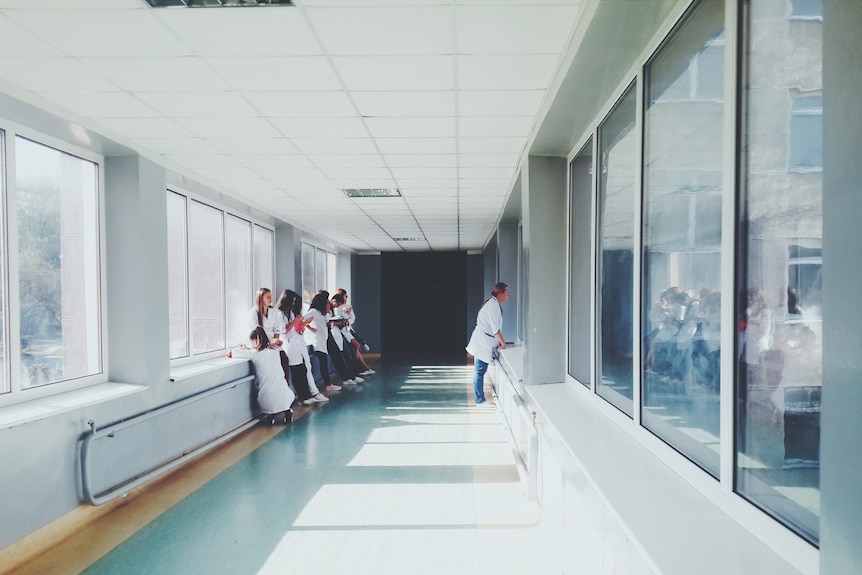 People waiting in a hospital corridor.