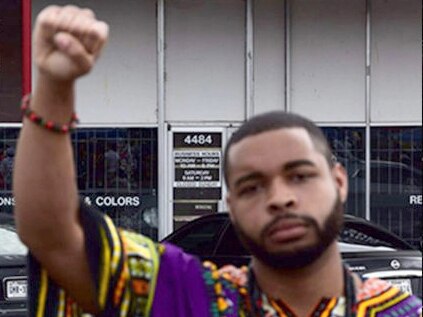 Dallas shootings suspect Micah Johnson with his fist raised in what is known as the "black power" stance.