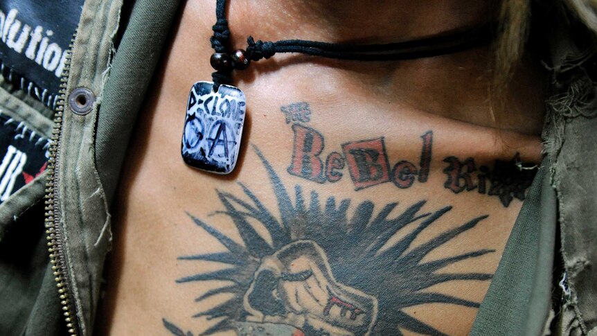 Oakar, member of punk band Rebel Riot, wears a tattoo with the band symbol